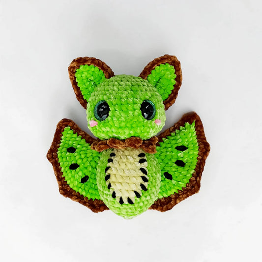 Kiwi Bat Crochet Pattern featuring bright green kiwi wings, seed embroidery and oversized bat ears
