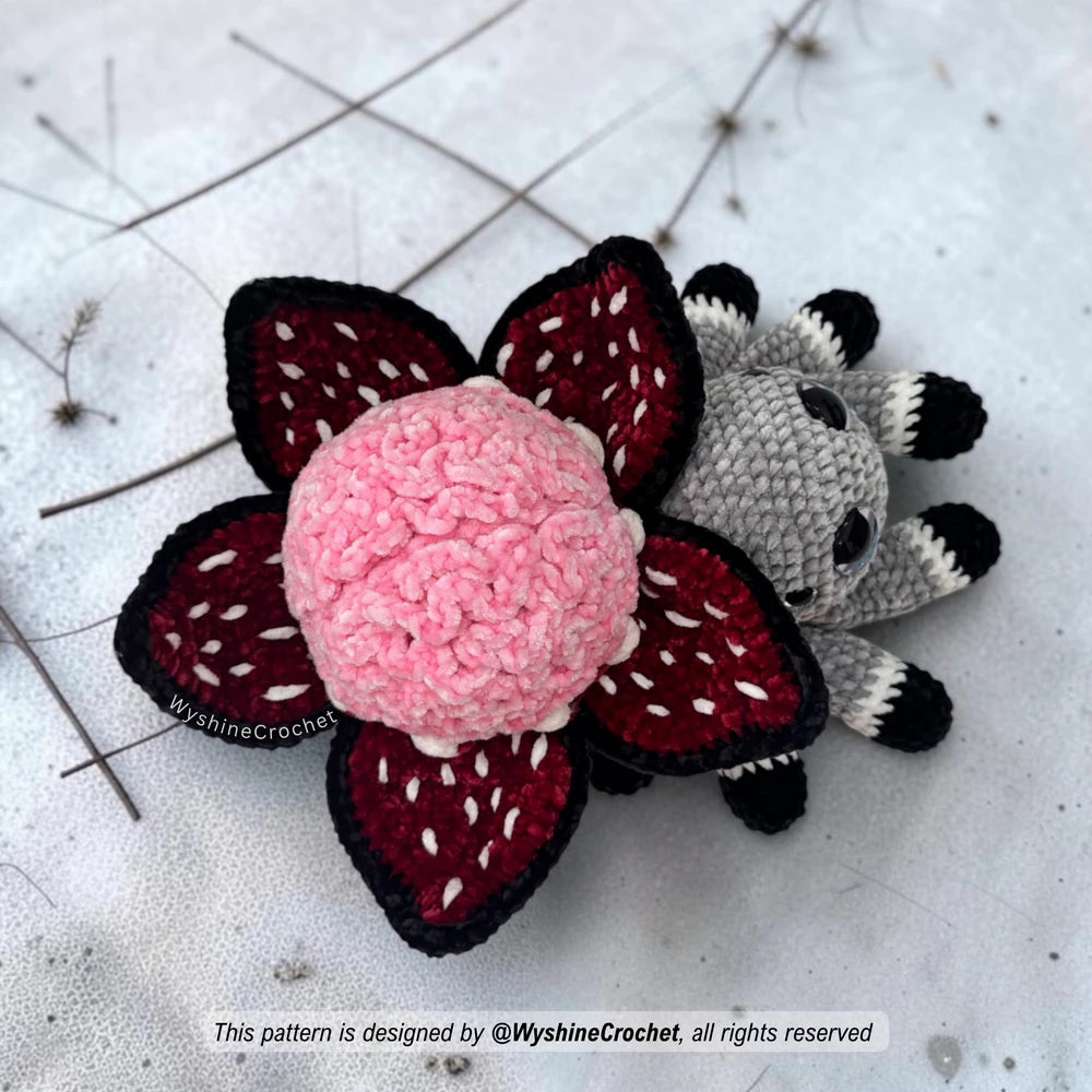 Amigurumi Halloween crochet pattern for a spooky cute plushie spider with brain flower decoration and handmade fall decor charm
