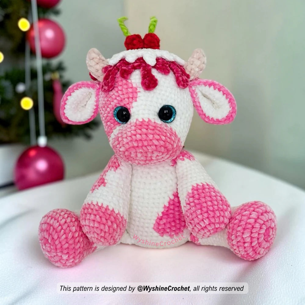 Cute cow amigurumi pattern with candy-inspired colors, soft horns, black safety eyes, and festive Christmas charm