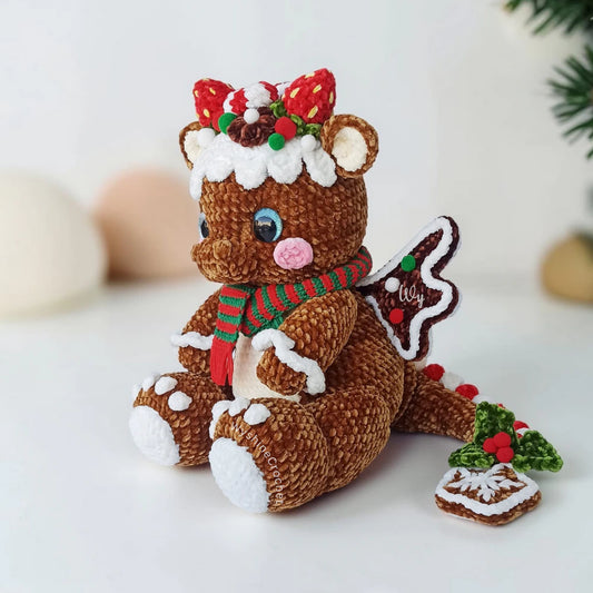 Chubby Gingerbread Dragon Crochet Pattern featuring a festive Christmas dragon amigurumi with strawberry horns, frosted wings, and striped scarf