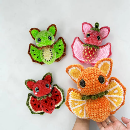 Four colorful Fruit Bat amigurumi characters displayed together for cozy fall and Halloween decor