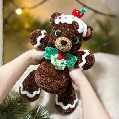 Gingerbread Bear Crochet Pattern finished Christmas amigurumi plushie with frosting details, green bow, and holly berries