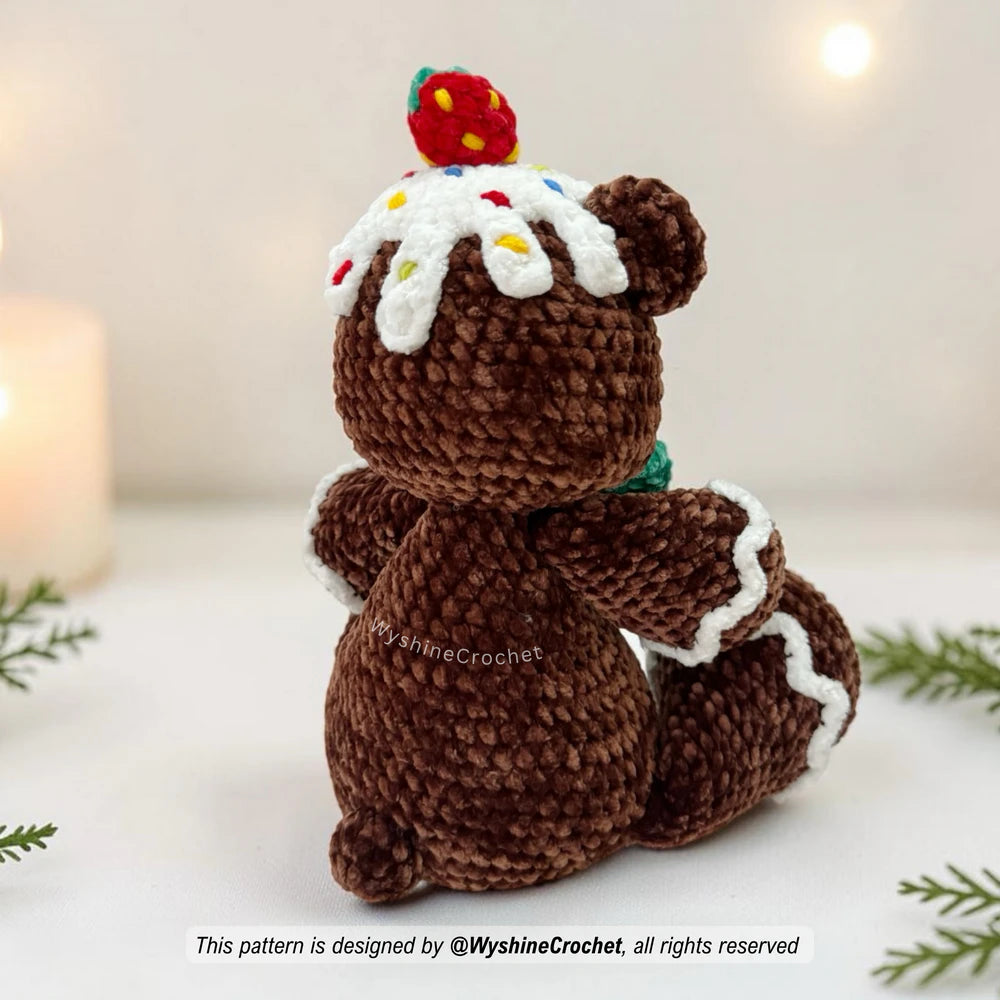 Holiday amigurumi bear crochet pattern with green bow, strawberry topping, and cozy gingerbread cookie-inspired style