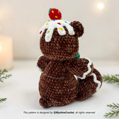 Holiday amigurumi bear crochet pattern with green bow, strawberry topping, and cozy gingerbread cookie-inspired style