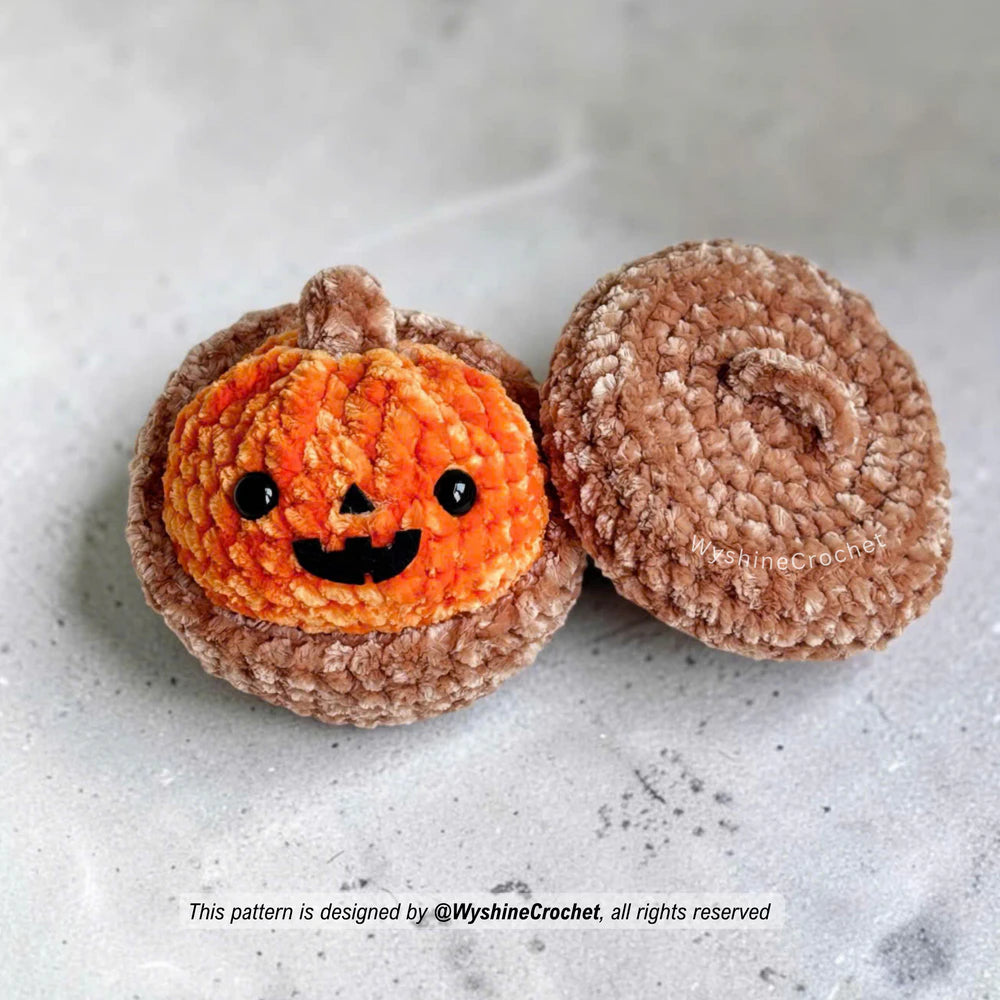 Pumpkin Dumpling crochet pattern photo with orange bao bun shape, safety eyes, and black felt Halloween face