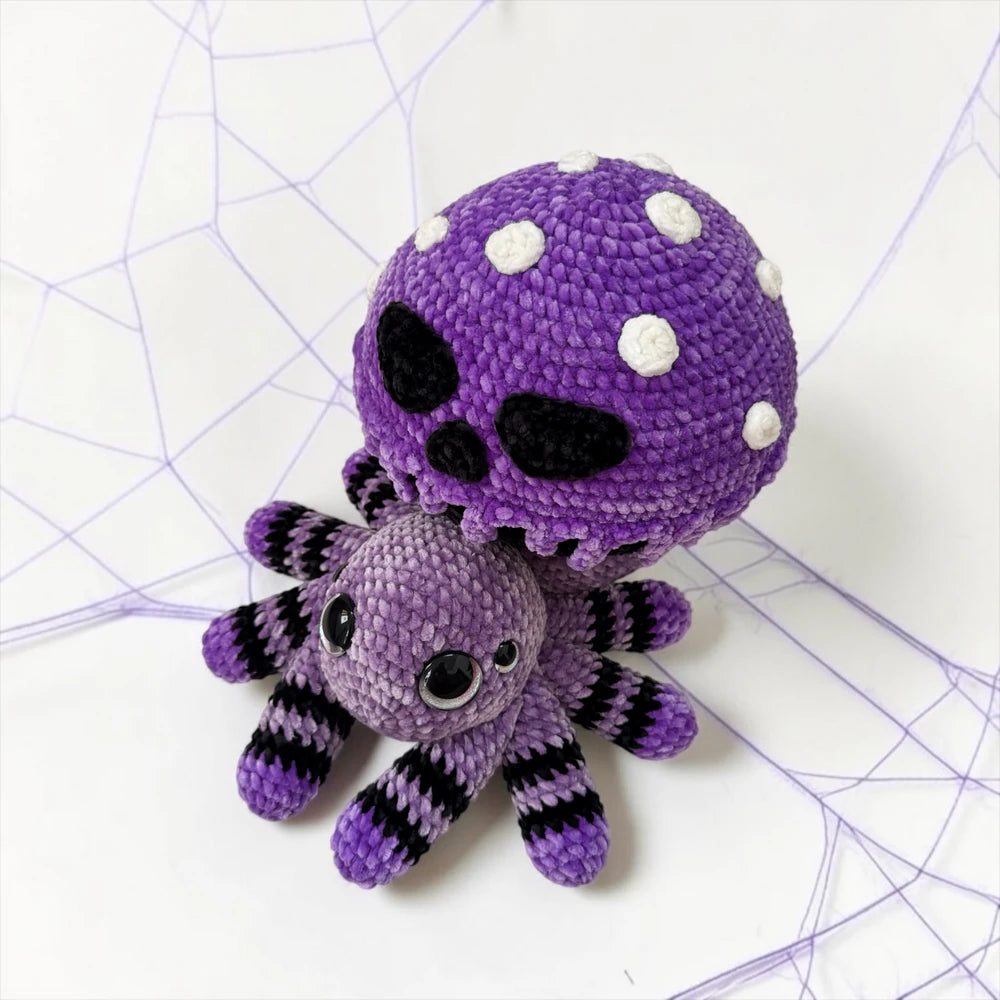 Poisoned Mushroom Spider Crochet Pattern finished Halloween amigurumi plushie with purple mushroom cap, skull face details, and eight spider legs
