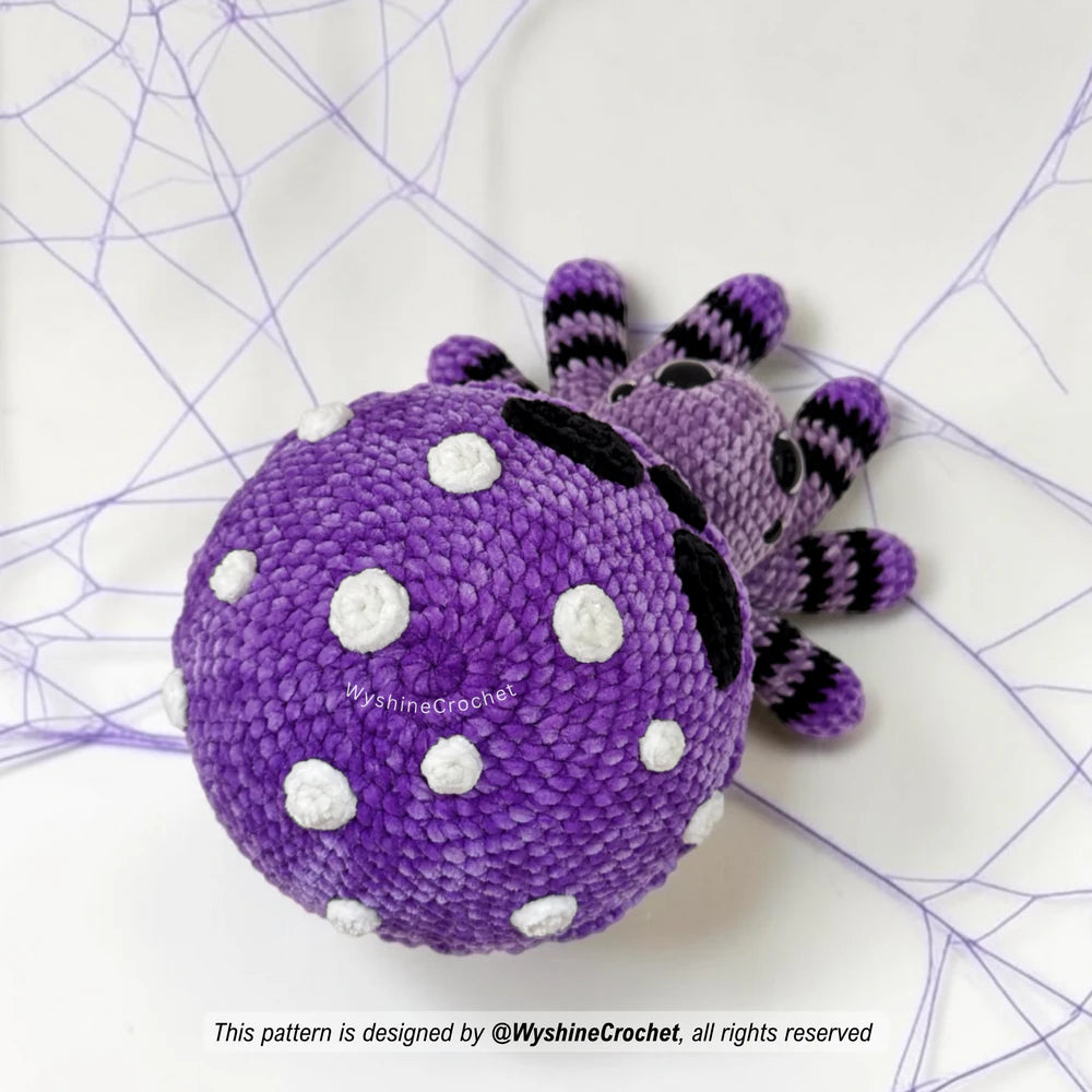 Poisoned Mushroom Spider crochet plushie close-up showing skull-style mushroom cap, glaze drips, white dots, and creepy cute Halloween details