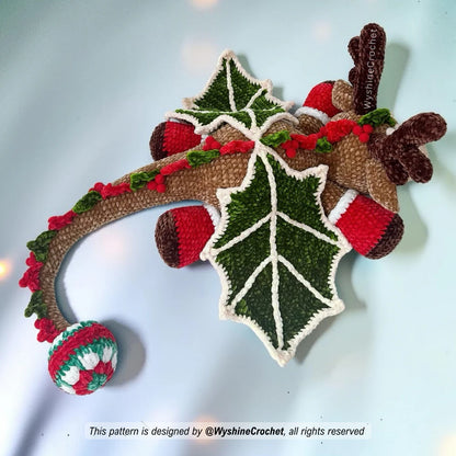 Reindeer Dragon crochet plushie close-up with 30 mm safety eyes, embroidered face details, antlers, and red nose
