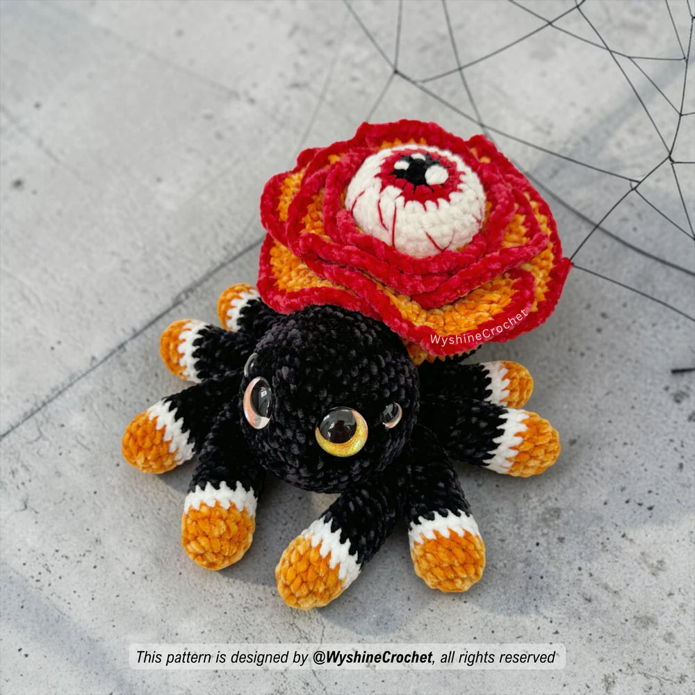 Spooky cute flower spider crochet pattern PDF featuring a rose-shaped body, watchful eye, eight legs, and Halloween amigurumi charm
