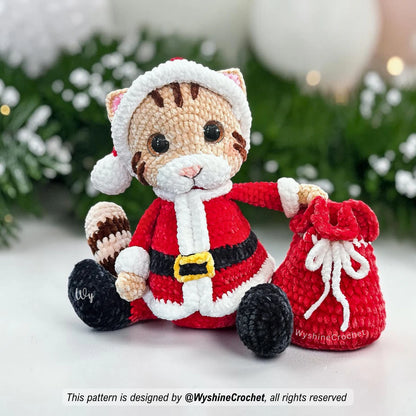 Cute Santa Cat amigurumi wearing a red Christmas hat with white trim, pink cat ears, and soft chenille yarn texture