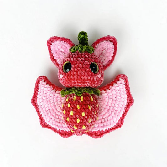 Strawberry Bat Crochet Pattern with pink wings, leafy details and strawberry-inspired amigurumi design